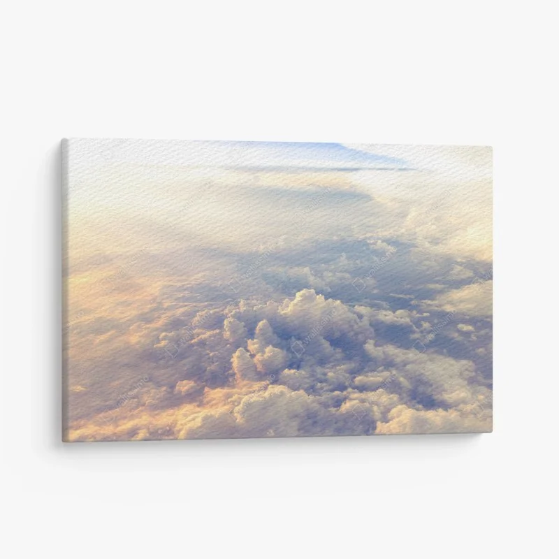 Canvas print sunlit clouds above the horizon