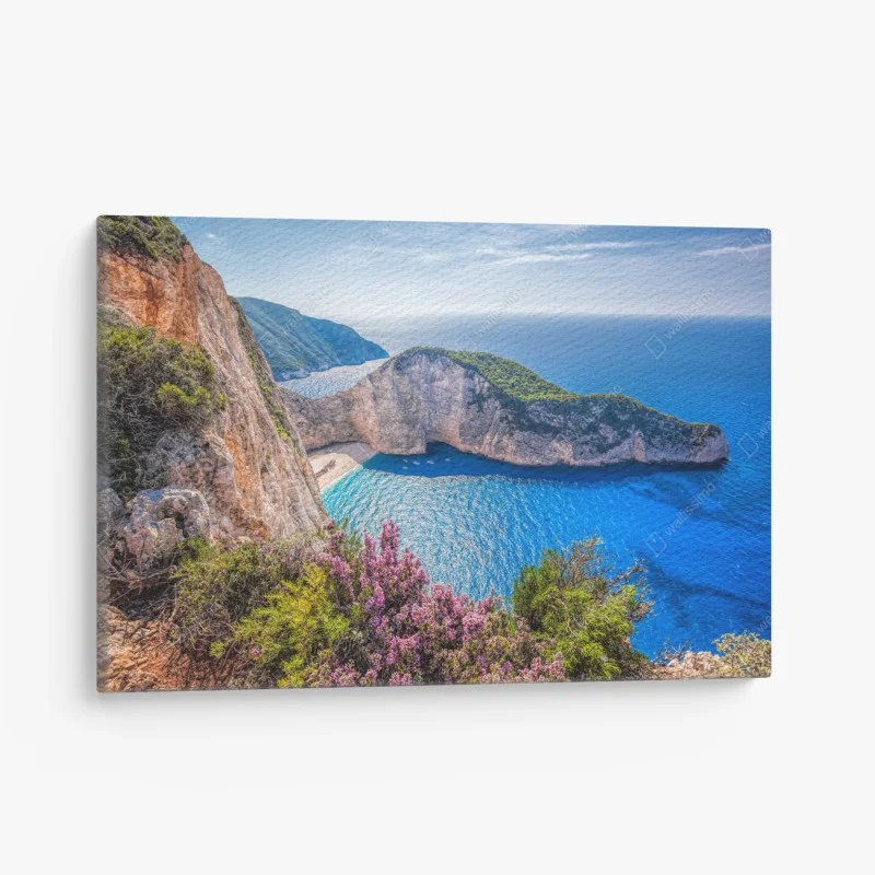 Canvas print Navagio beach sunset with turquoise sea and wildflowers