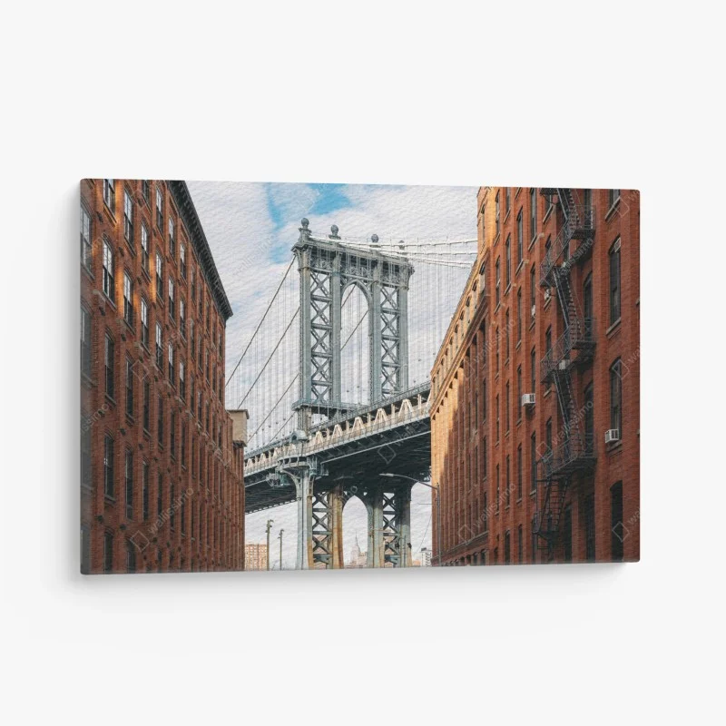 Canvas print Brooklyn bridge framed by brick buildings at sunset