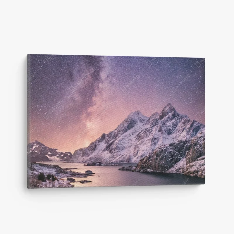 Canvas print milky way over snowy mountains in Norway