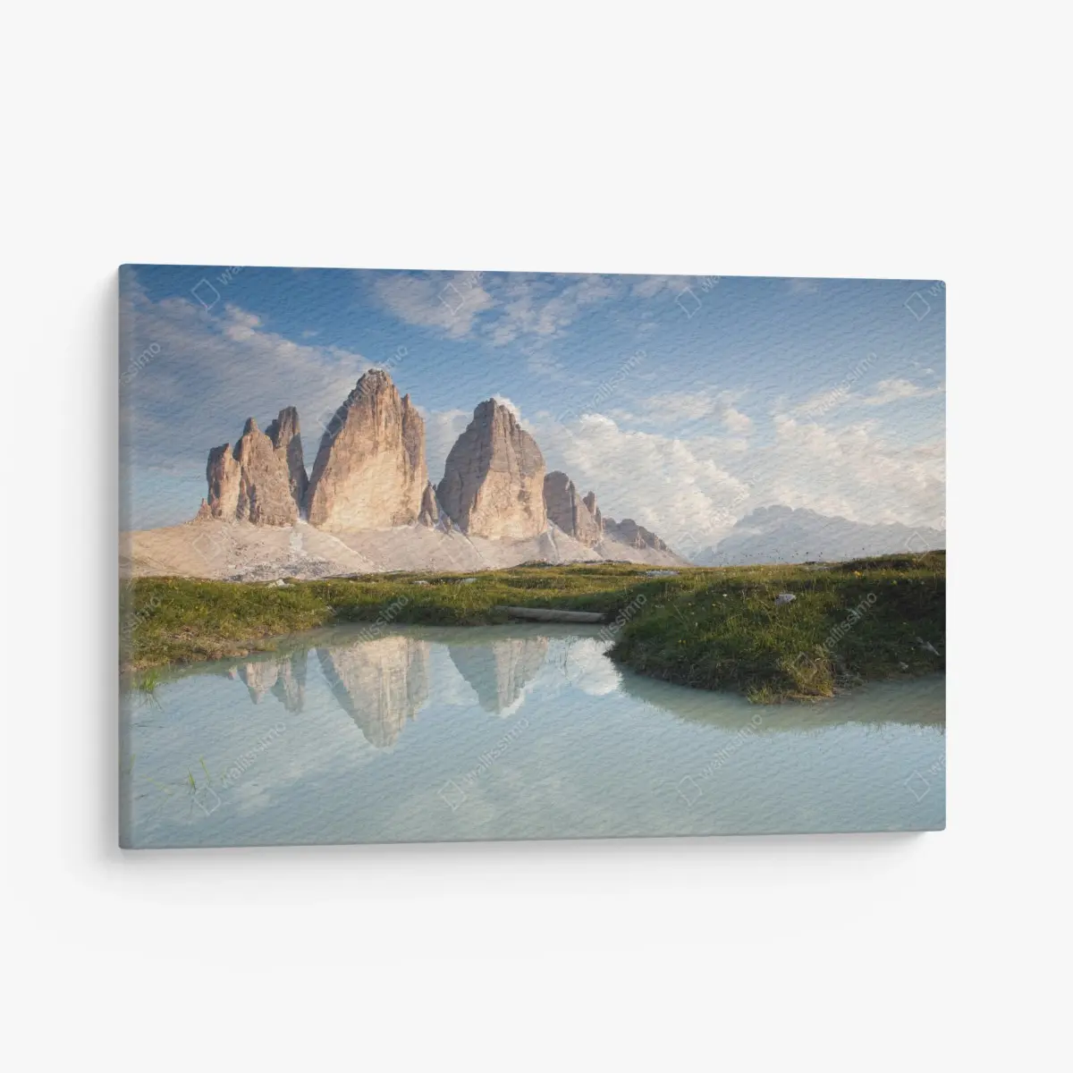 Canvas print sunlit alpine peaks reflected in a tranquil lake • Wallissimo®