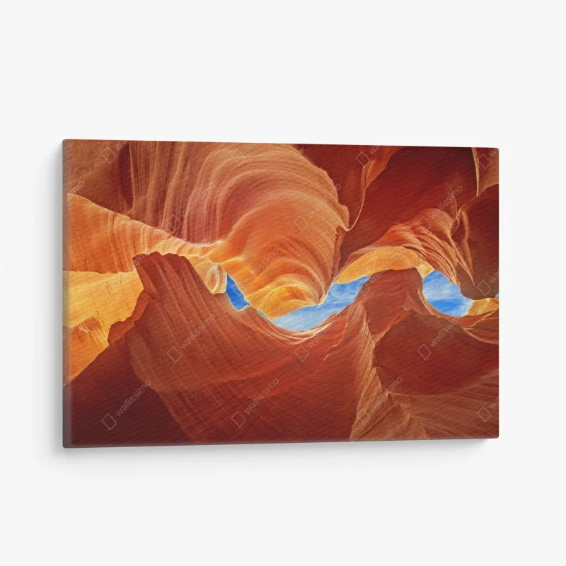 Canvas print Antelope Canyon swirling sandstone and blue sky