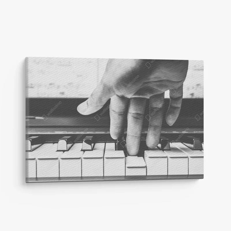 Canvas print hand on piano keys in grayscale