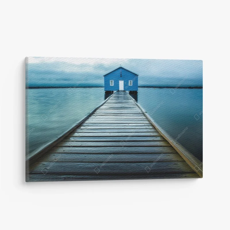 Canvas print blue boathouse at the end of the pier