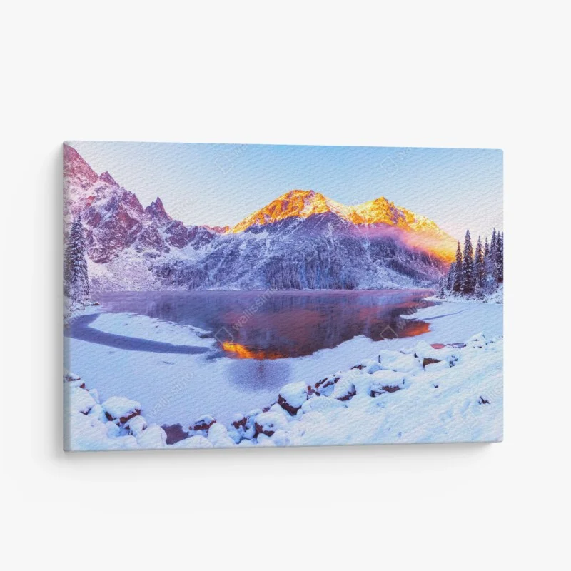 Canvas print sunlit mountains over frozen alpine lake