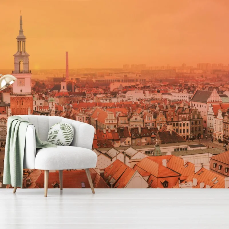 Wall mural warm sunset over historic city rooftops