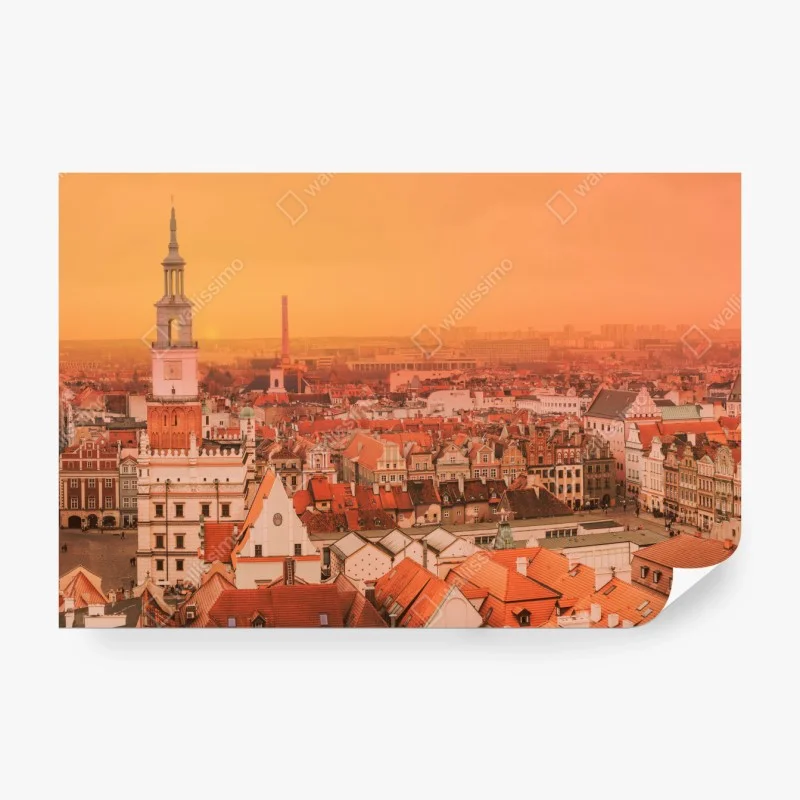 Wall mural warm sunset over historic city rooftops