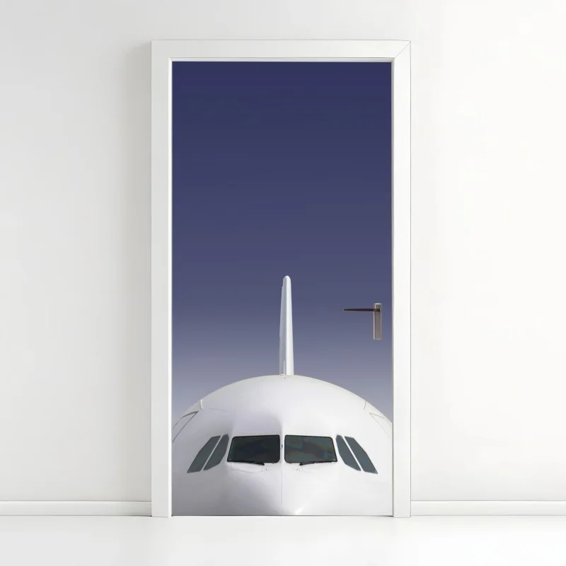 Door sticker front view of airplane against blue sky