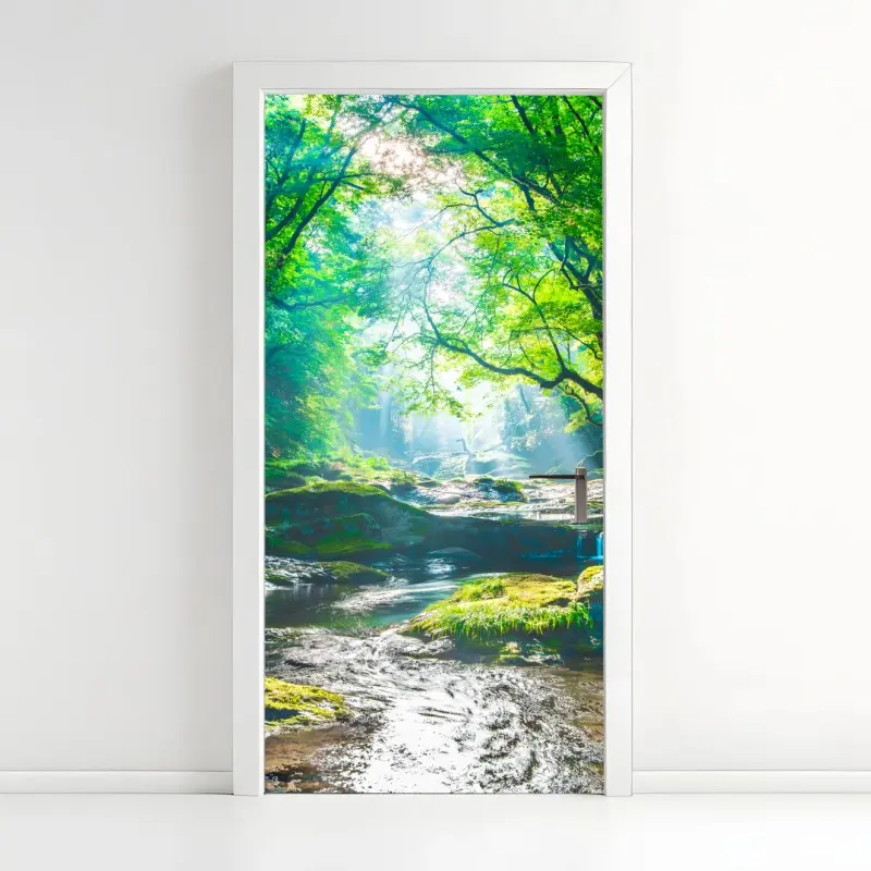 Door sticker sunlit forest stream with mossy rocks