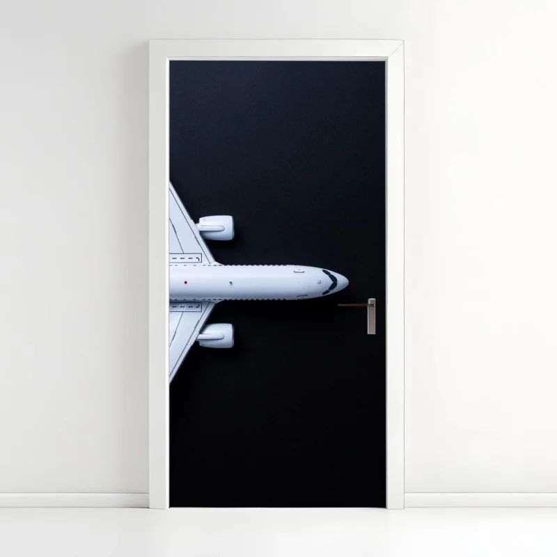 Door sticker white airplane top view on black background