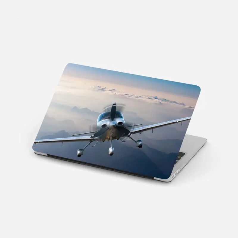 Laptop sticker silver propeller plane over misty mountains