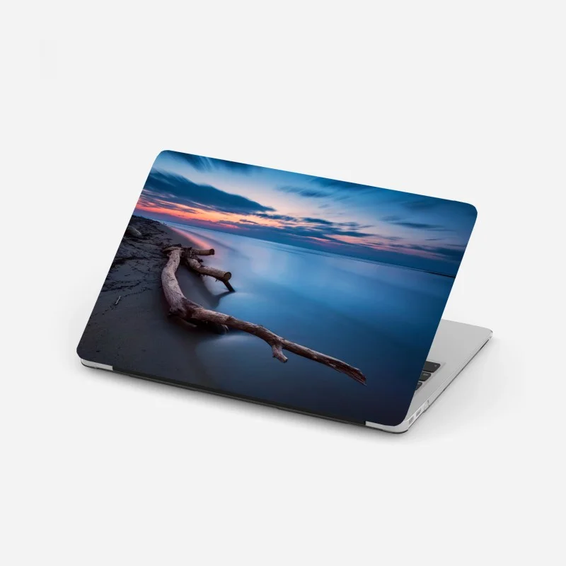 Laptop sticker twilight driftwood on a calm beach