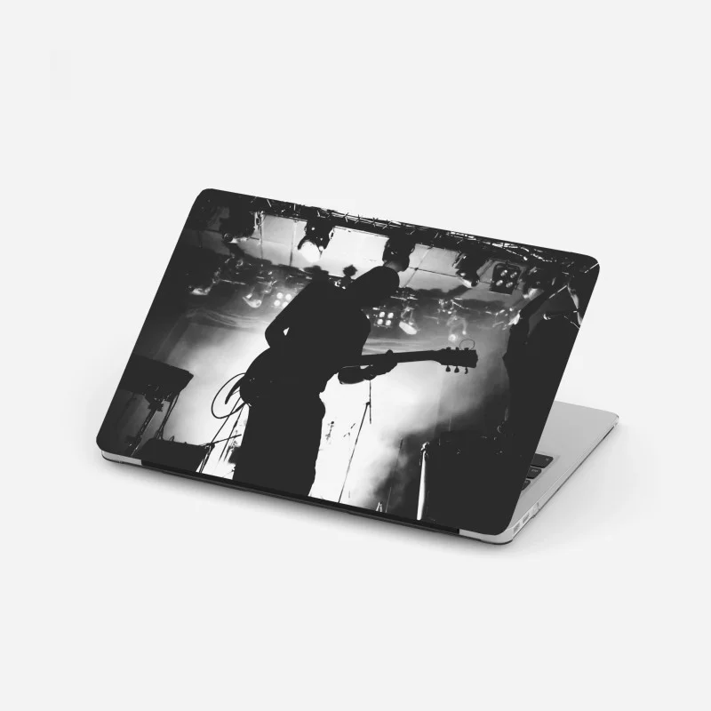 Laptop sticker guitarist silhouette at a live show