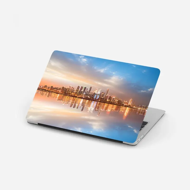 Laptop sticker city skyline reflected at dusk