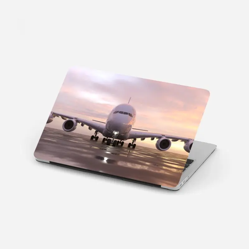 Laptop sticker front view jet on runway at sunset