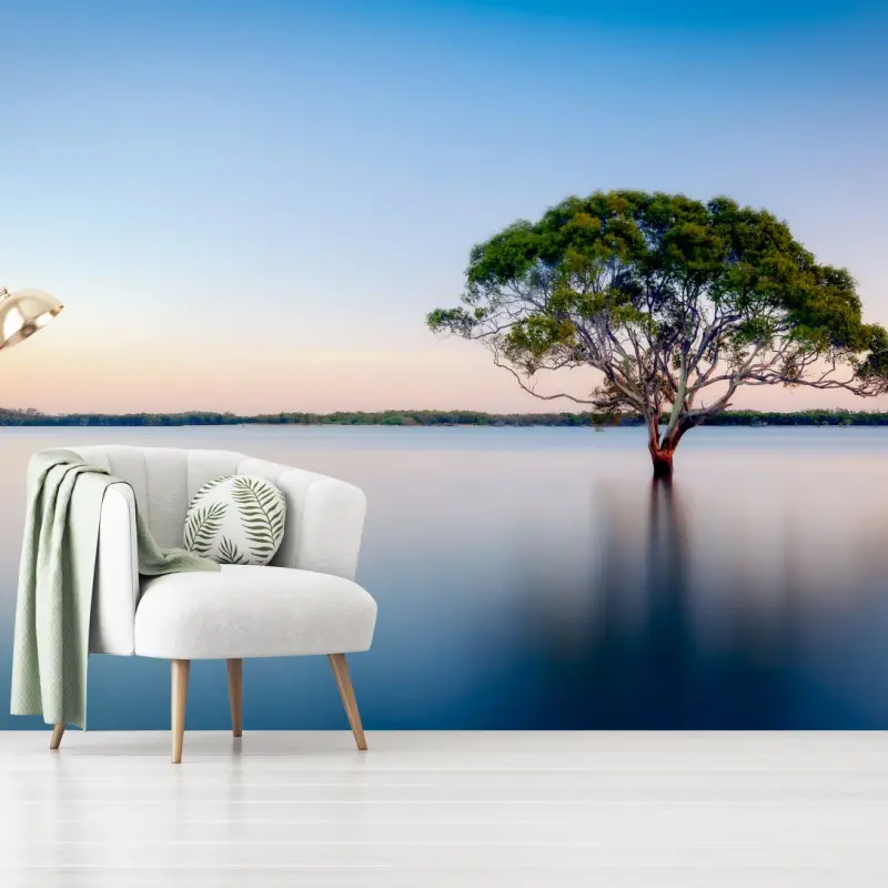 Wall mural solitary tree over a tranquil lake