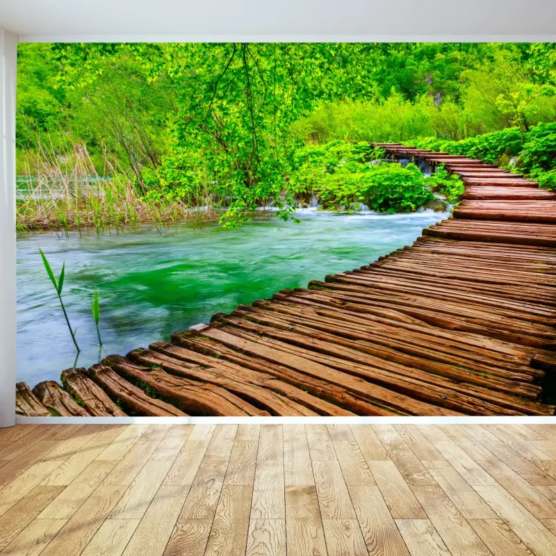 Wall mural serene green boardwalk over river