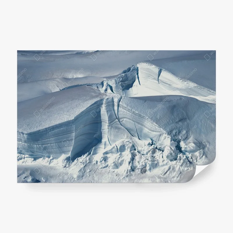Wall mural pristine glacier crevasse in blue light