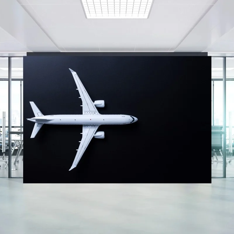 Wall mural white airplane top view on black background