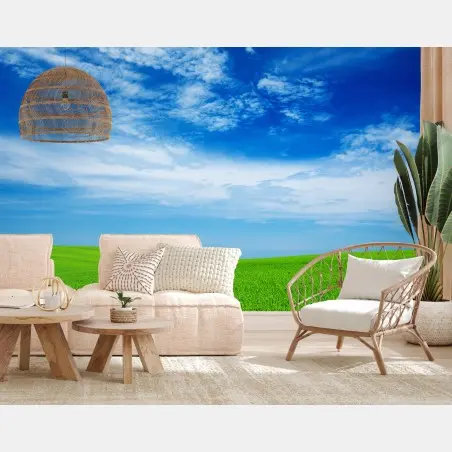 Wall mural rolling green meadow under a bright blue sky • Wallissimo®