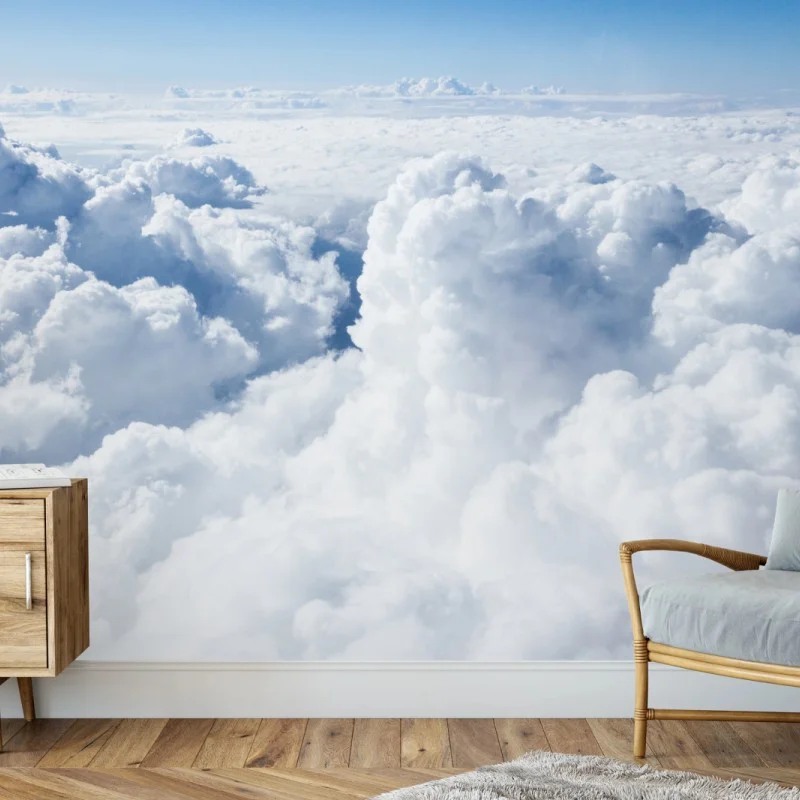 Wall mural view from above: soft clouds and blue sky