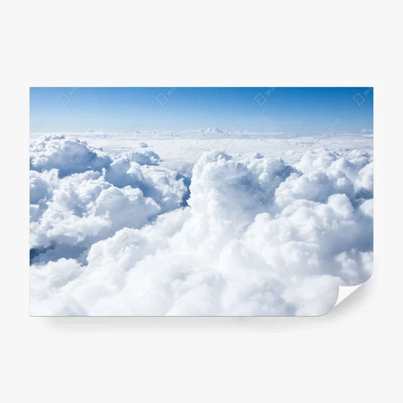 Wall mural view from above: soft clouds and blue sky