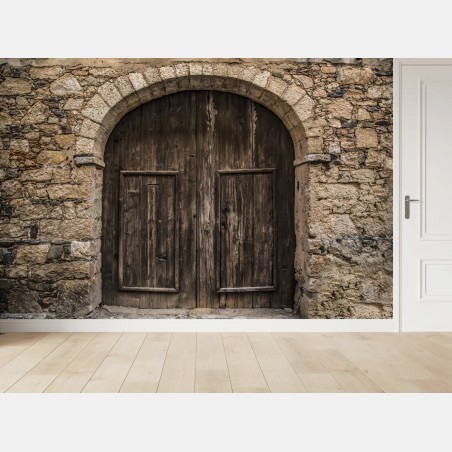 Wall mural rustic wooden door with stone arch • Wallissimo®