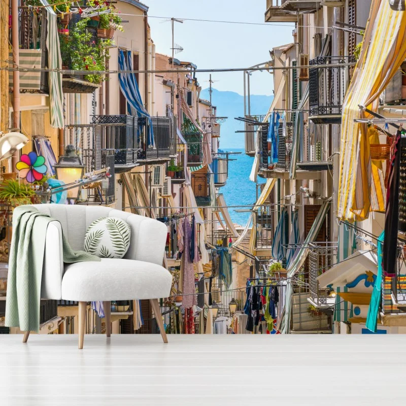 Wall mural sunlit mediterranean alley with sea view