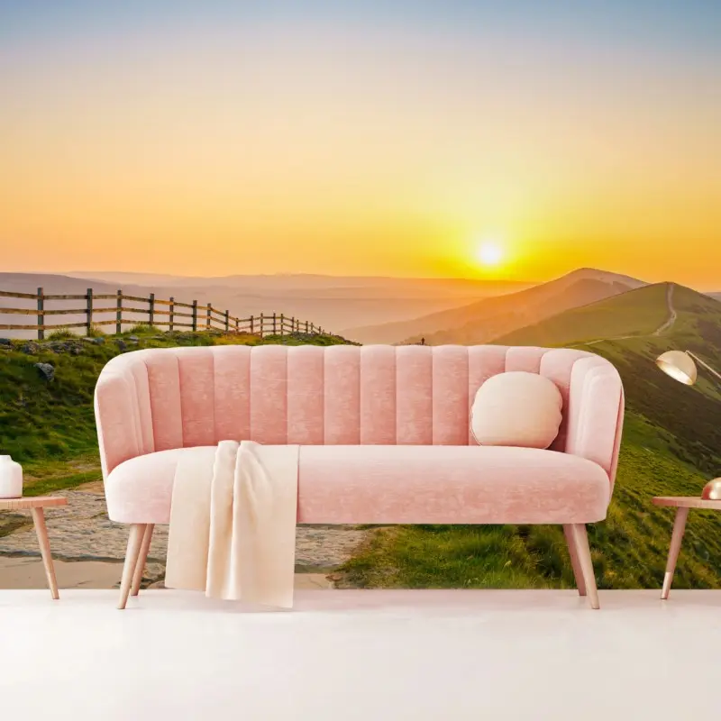 Wall mural sunlit mountain ridge at sunrise
