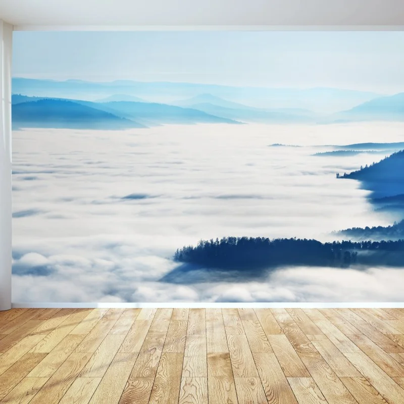 Wall mural misty mountain panorama over fog-filled valley