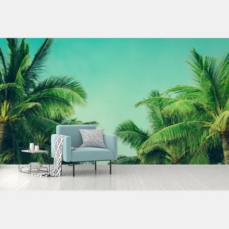 Wall mural tropical palm canopy under turquoise sky • Wallissimo®