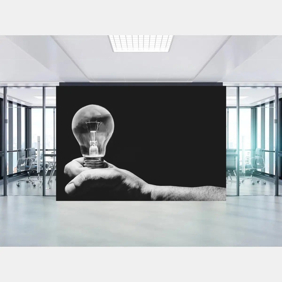 Wall mural monochrome hand holding light bulb • Wallissimo®