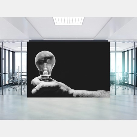 Wall mural monochrome hand holding light bulb • Wallissimo®