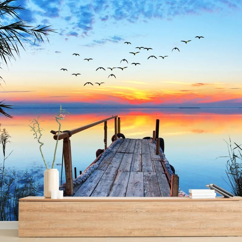 Wall mural sunset pier over tranquil lake