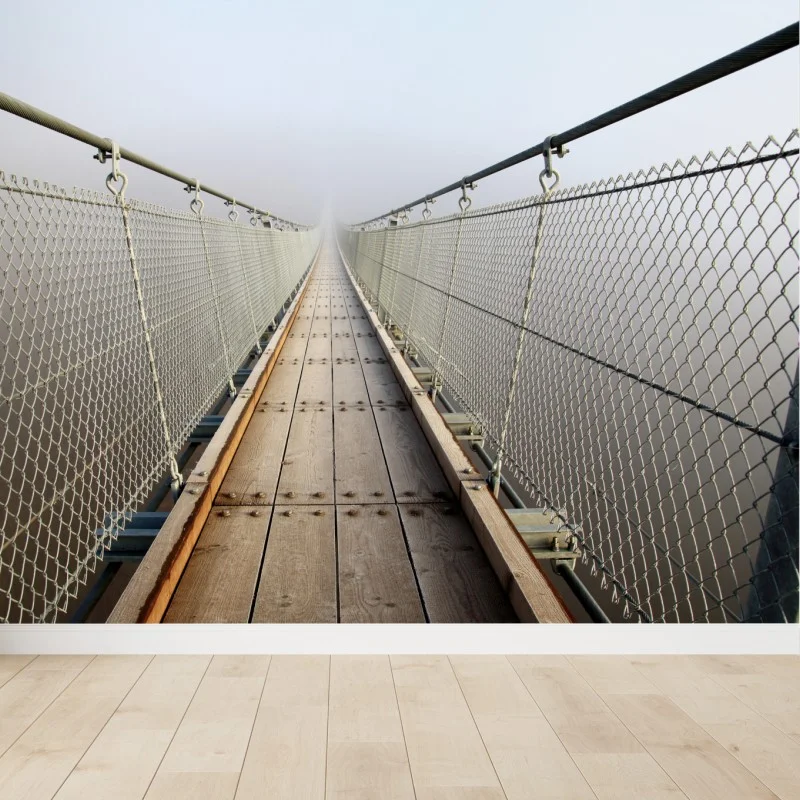 Wall mural misty suspension bridge leading into fog