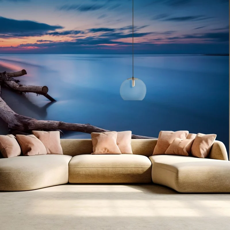 Wall mural twilight driftwood on a calm beach
