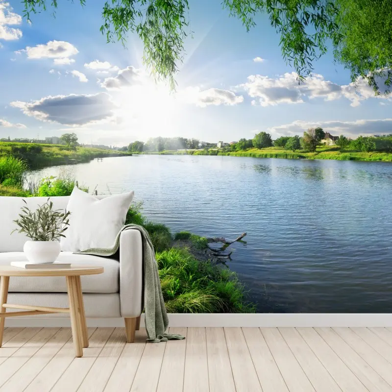 Wall mural sunlit riverside landscape with lush greenery
