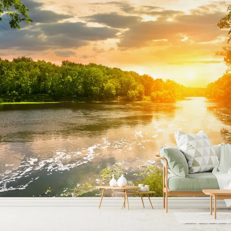 Wall mural serene riverside sunset over lush forest