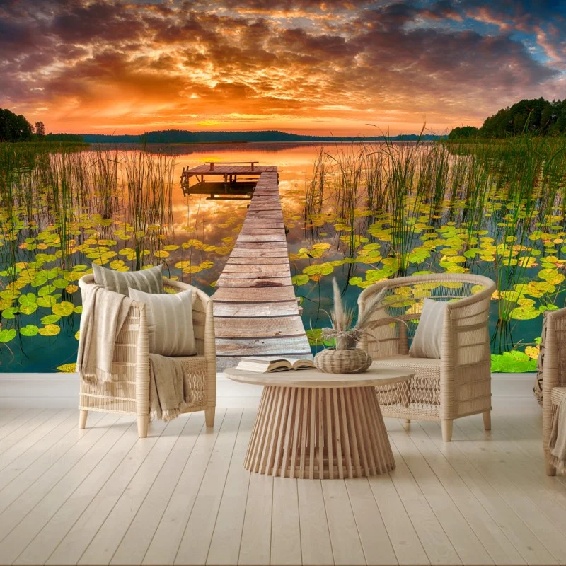 Wall mural sunrise over tranquil lake with wooden pier