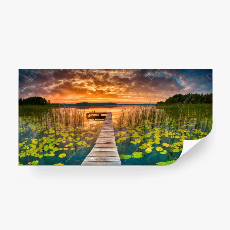 Wall mural sunrise over tranquil lake with wooden pier