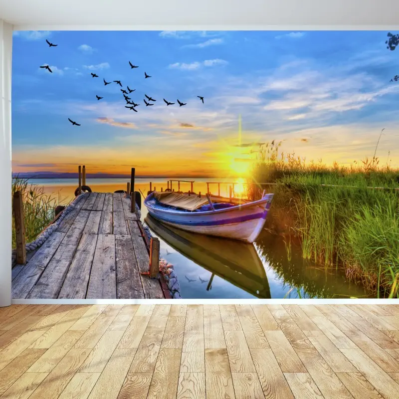 Wall mural sunset boat at tranquil lake pier