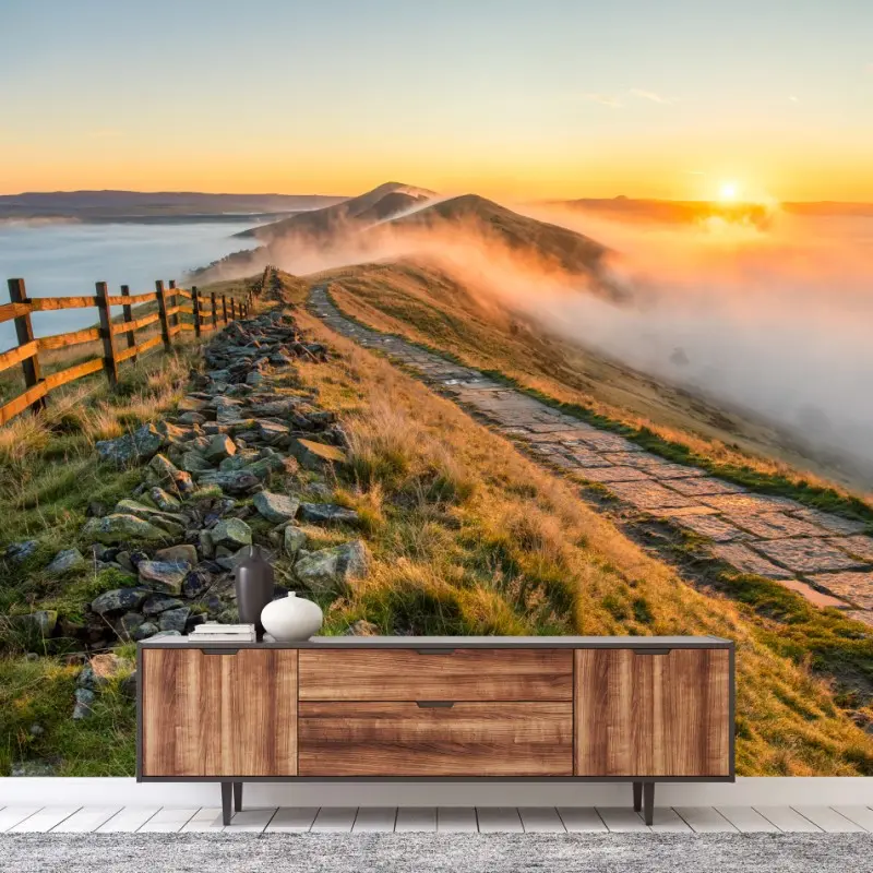 Wall mural sunrise over a misty ridge with a stone path