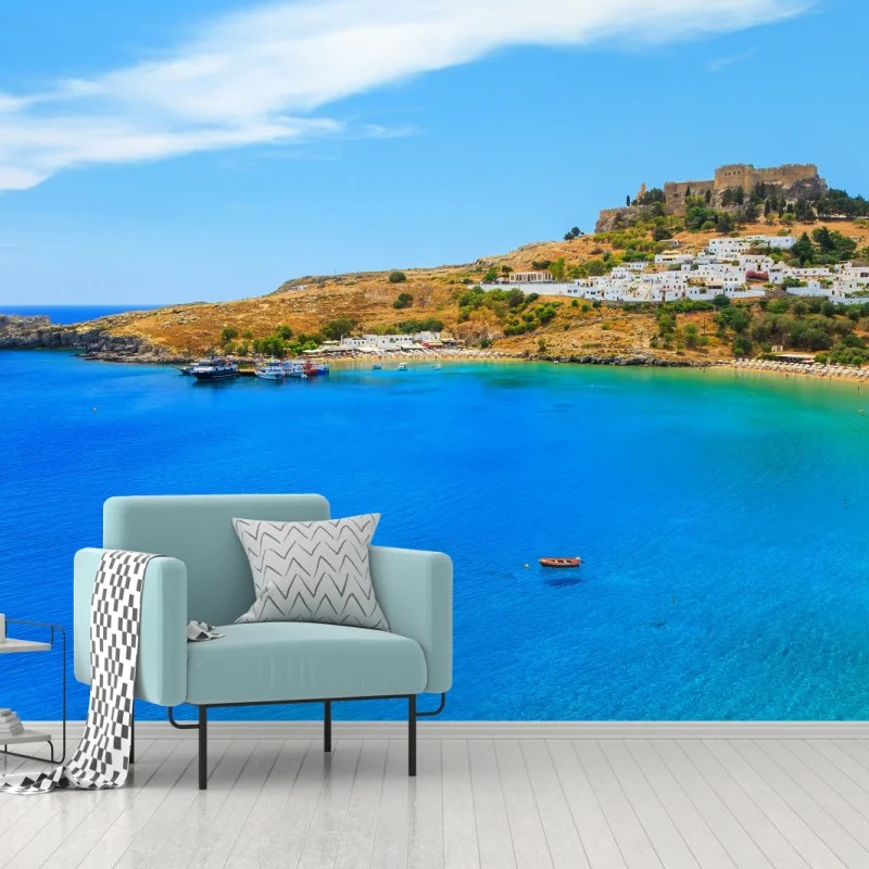 Wall mural sunlit coastal bay with hillside village