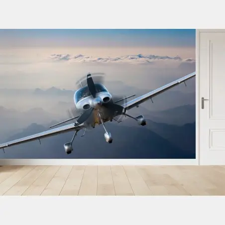 Wall mural silver propeller plane over misty mountains • Wallissimo®