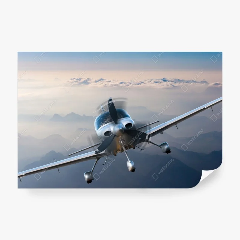 Wall mural silver propeller plane over misty mountains