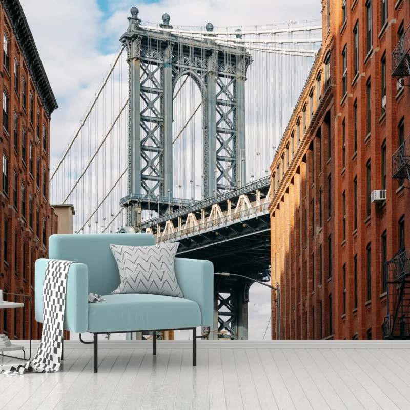 Wall mural Brooklyn bridge framed by brick buildings at sunset