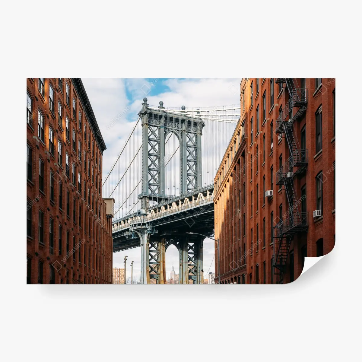 Wall mural Brooklyn bridge framed by brick buildings at sunset • Wallissimo®