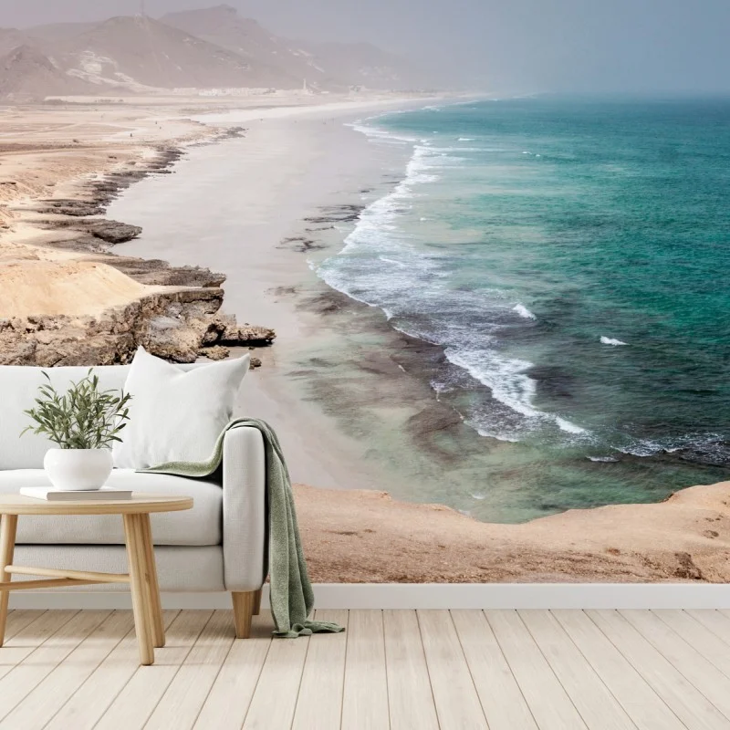 Wall mural serene turquoise coastline over desert cliffs