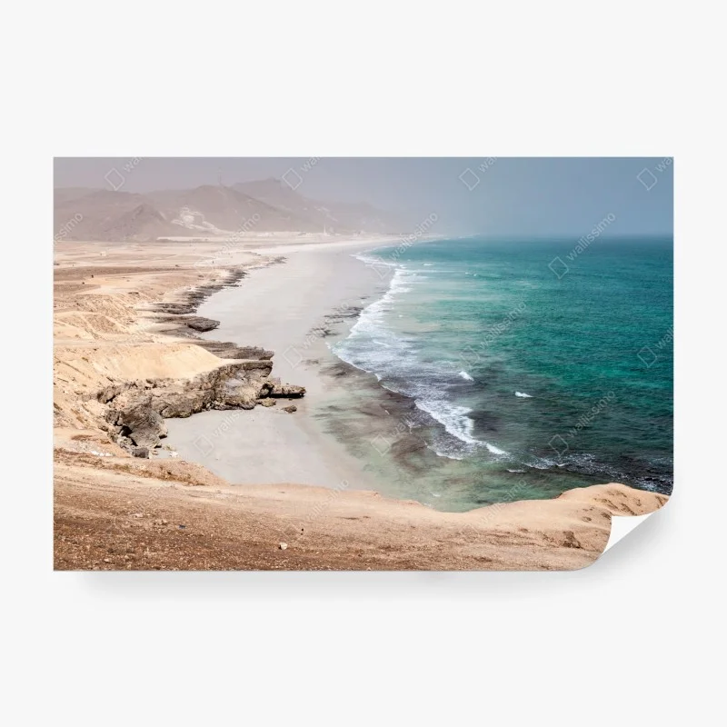Wall mural serene turquoise coastline over desert cliffs