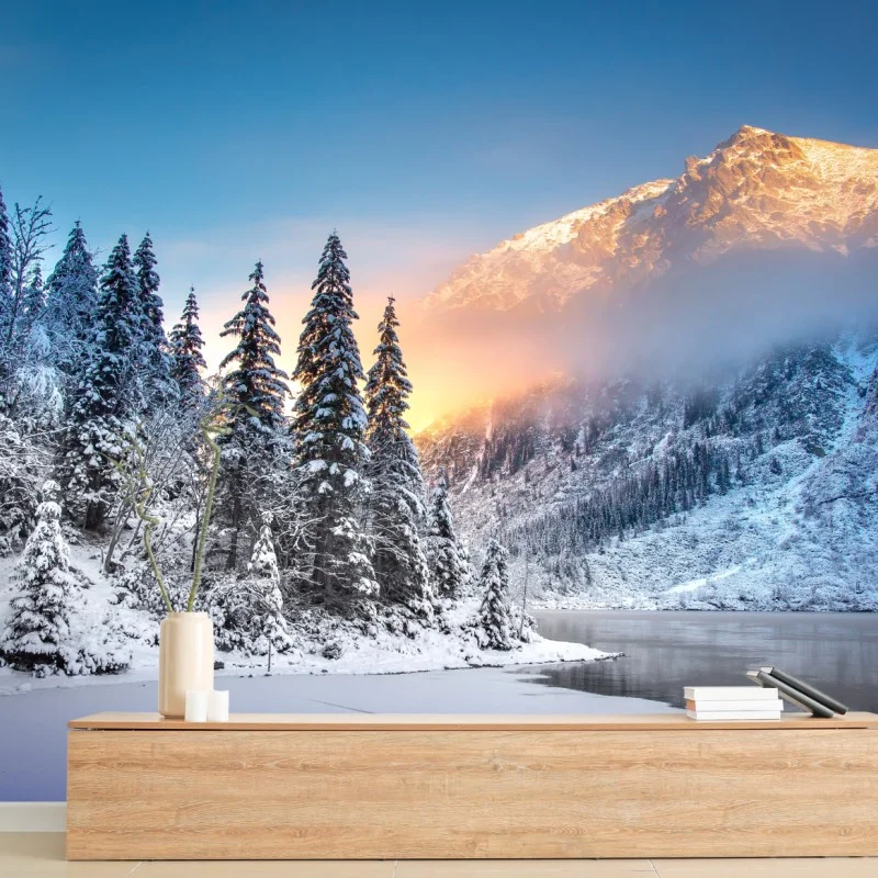 Wall mural winter sunrise over snowy mountain lake